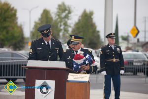 Two military personnel at podium for 2016 Veteran's Day Anniversary.