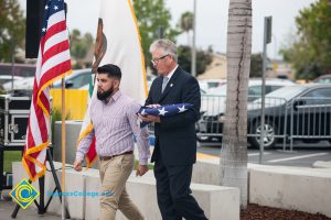 Bob Simpson carrying folded flag