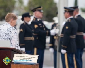 Military personnel folding the American flag.