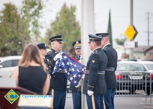 Military personnel folding the American flag.