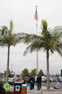 American flag between two palm trees.