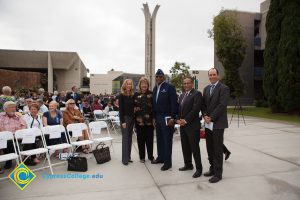 Men and women standing with a veteran