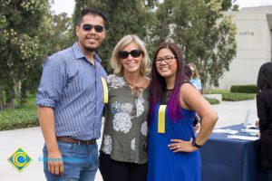 Two women and a man smiling