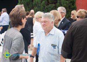 A man in a white shirt speaking with Young Kim.