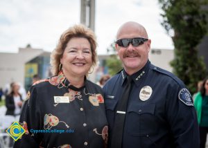 A Cypress Police Officer with a woman in a black blouse.