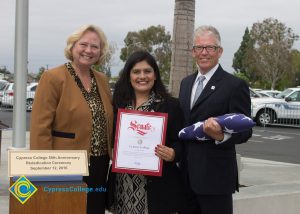 Bob Simpson, Cheryl Marshall, and another woman holding a certificate.