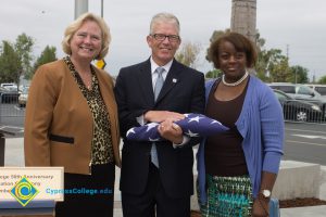 Dr. Cheryl Marshall and another woman standing with Bob Simpson.