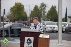 Woman speaking at podium.