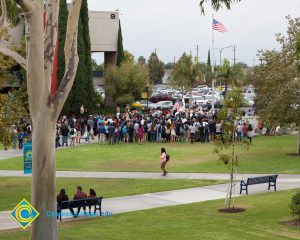 Crowd gathered on campus lawn.