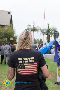 Woman wearing t-shirt that reads, "Try Stepping On This One" with American flag.