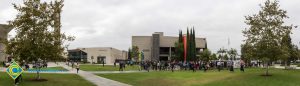 Crowd gathered on campus lawn for Veterans Day anniversary event.