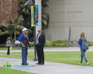 Two gentlemen talking on campus.