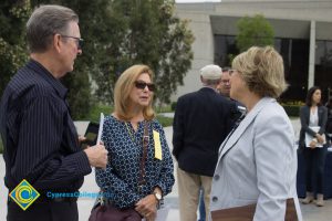 Two women and a man talking