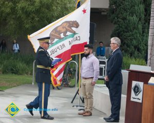 Folded American flag is presented to Bob Simpson