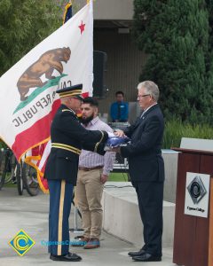 Folded American flag being presented to Bob Simpson.