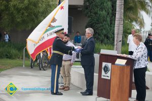 Folded American flag being presented to Bob Simpson.