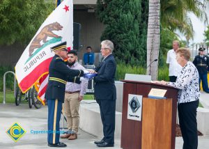 Folded American flag being presented to Bob Simpson.