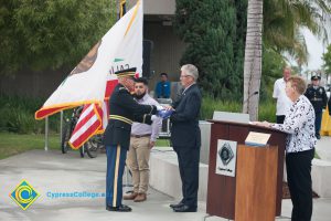 Folded American flag being presented to Bob Simpson.