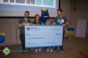 Students holding their prize check at the Ideathon event.