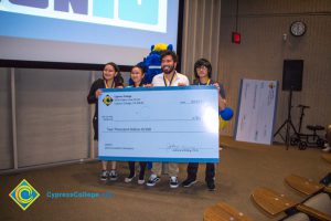 Students holding their prize check at the Ideathon event.