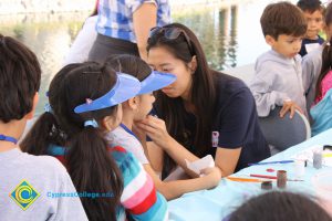 A young girl getting her face painted at the 2014 KinderCaminata.