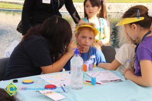 A young girl getting her face painted at the 2014 KinderCaminata.