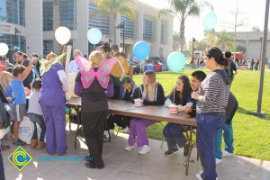 2014 KinderCaminata information booth with students and staff.