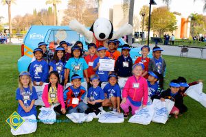 A group of kindergartners with Snoopy.