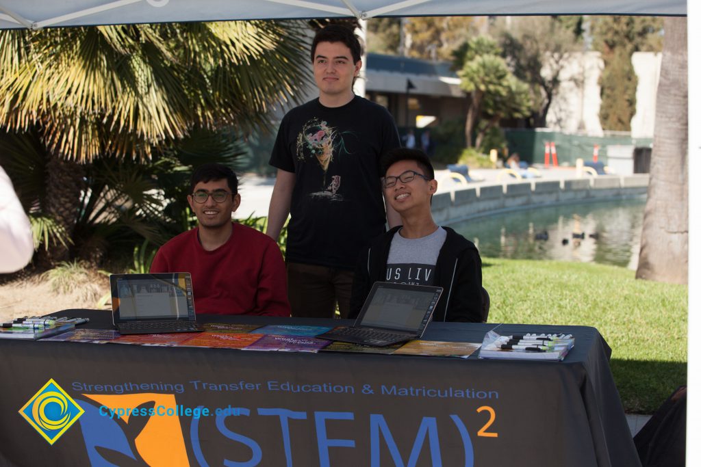 Students at the (STEM)² information table at Club Rush.