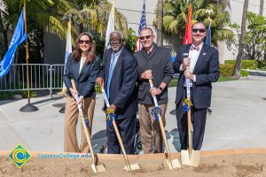 Kai Stearns, Ned Doffoney, Fred Williams and Greg Schultz holding shovels in a dirt box at VRC Groundbreaking.