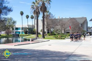 Participants running in the 3rd Annual Veteran's 5k on campus running near the pond.