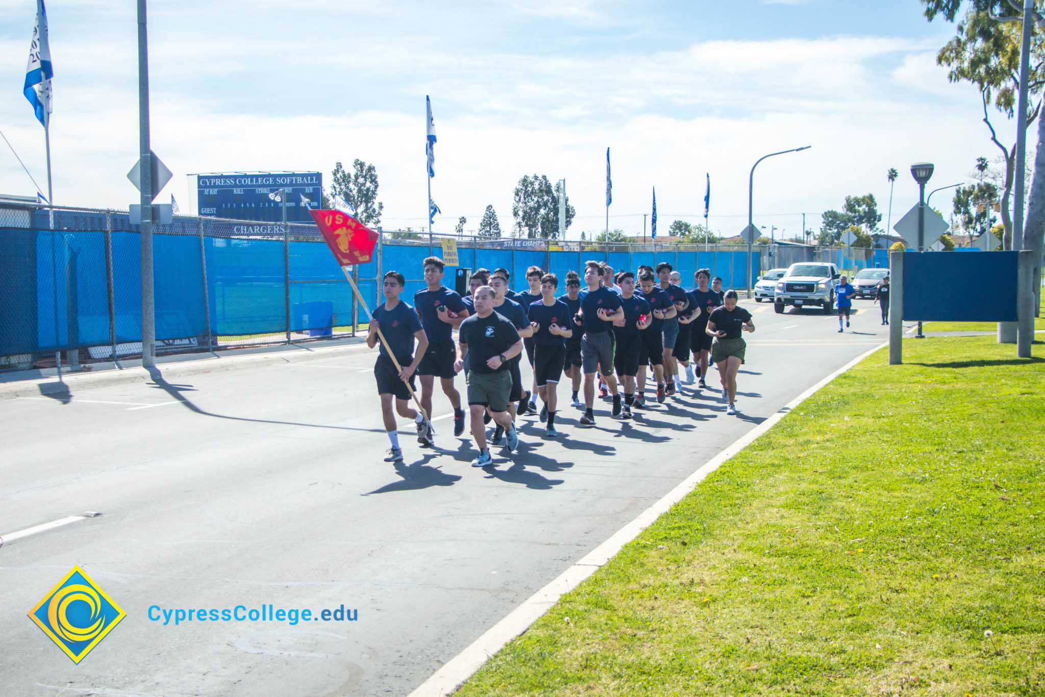 A group of runners carrying the United States Marine Corps Flag.