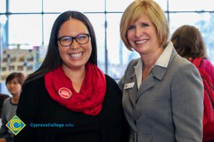 President JoAnna Schilling with Sarah Coburn, who is wearing black with a red scarf.