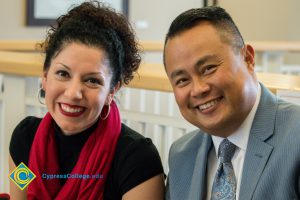 Dr. Paul de Dios and a woman wearing a black shirt and red scarf.