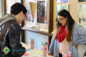 Students looking down at information table.