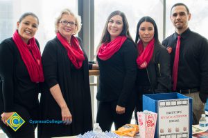 Career advisors wearing black shirts with red scarves and tie.