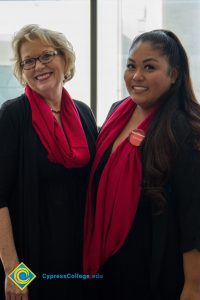 Deann Birch and a woman with a red scarf smiling.