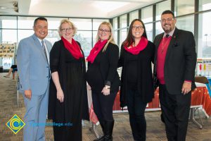 Paul de Dios, Deann Burch, two women in black with red scarves, and Gary Gopar.