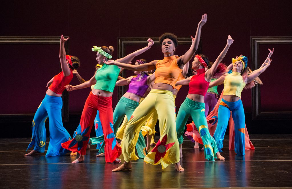 Dancers on stage in colorful costumes