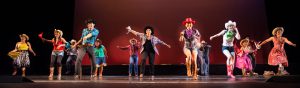 Dancers on stage wearing western costumes