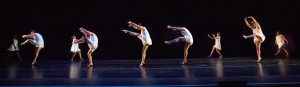 Dancers on stage wearing white dresses