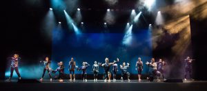 Dancers on stage wearing black costumes