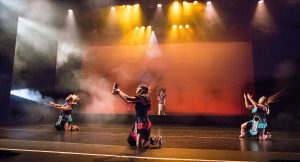 Dancers on stage wearing Native American costumes