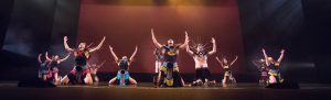 Dancers on stage wearing Native American costumes