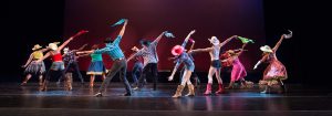 Dancers on stage wearing western costumes