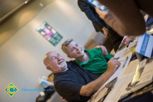 Holocaust Sam Silberbery poses with a young boy in a green shirt at the 2018 Yom HaShoah event.