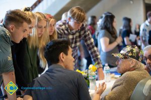 Students surround Holocaust survivor Gerda Seifer during the 2018 Yom HaShoah event.