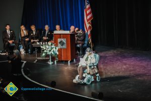 Holocaust survivor Gerda Seifer in a wheelchair on stage at the 2018 Yom HaShoah event.