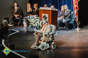 Holocaust survivor Gerda Seifer in a wheelchair on stage at the 2018 Yom HaShoah event.