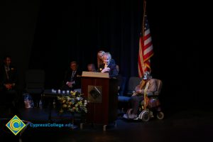 Two women at the podium while others look on during the 2018 Yom HaShoah event.